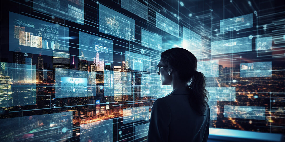 A woman is silhouetted against a futuristic wall of screens displaying data, showing how glass data storage could serve high volumes of cloud data efficiently and sustainably.